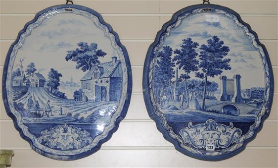A pair of 19th century Dutch delft blue and white cartouche shaped wall plaques